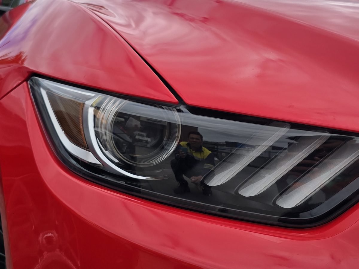 Ford Mustang headlight after restoration, clear and glossy