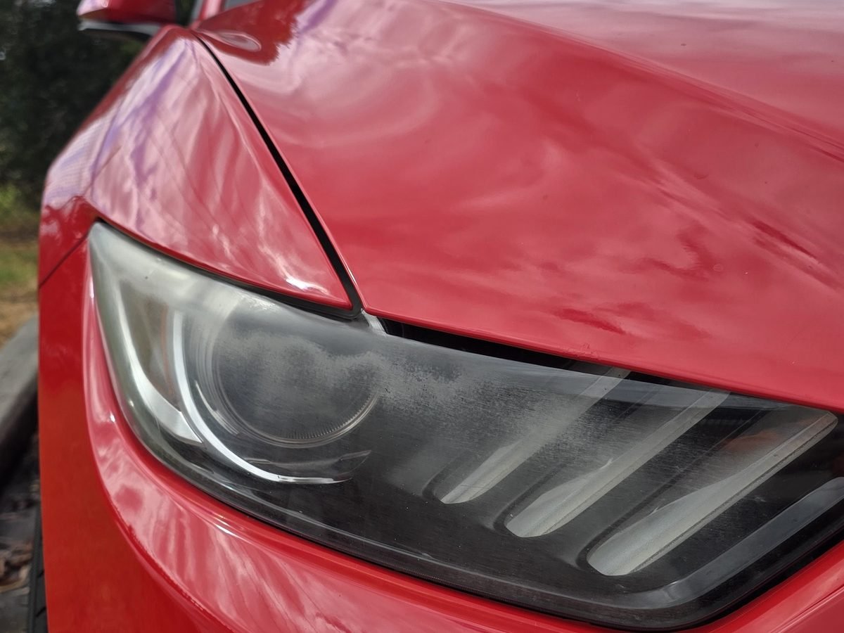 Ford Mustang headlight before restoration, dull and filmy